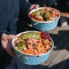 Colorful poke bowls served in personalized salad bowls