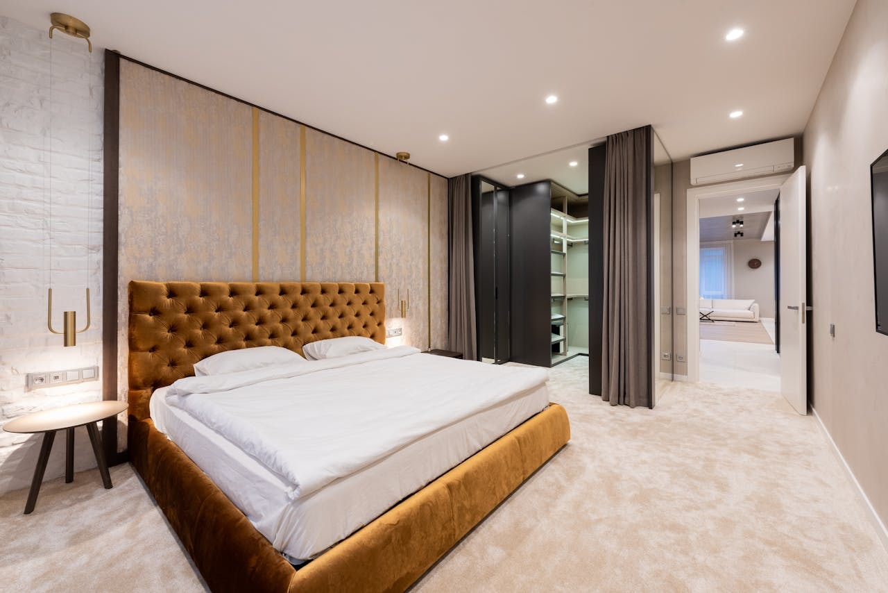 Modern hotel bedroom with table next to bed and wardrobe
