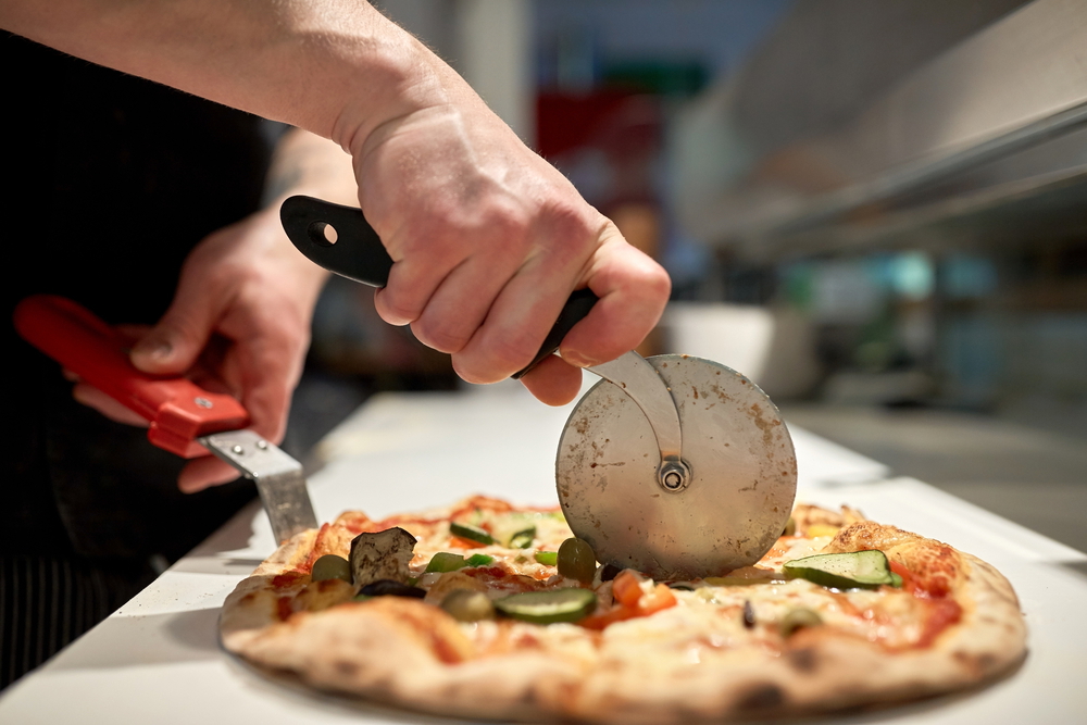 chef using a pizza cutter