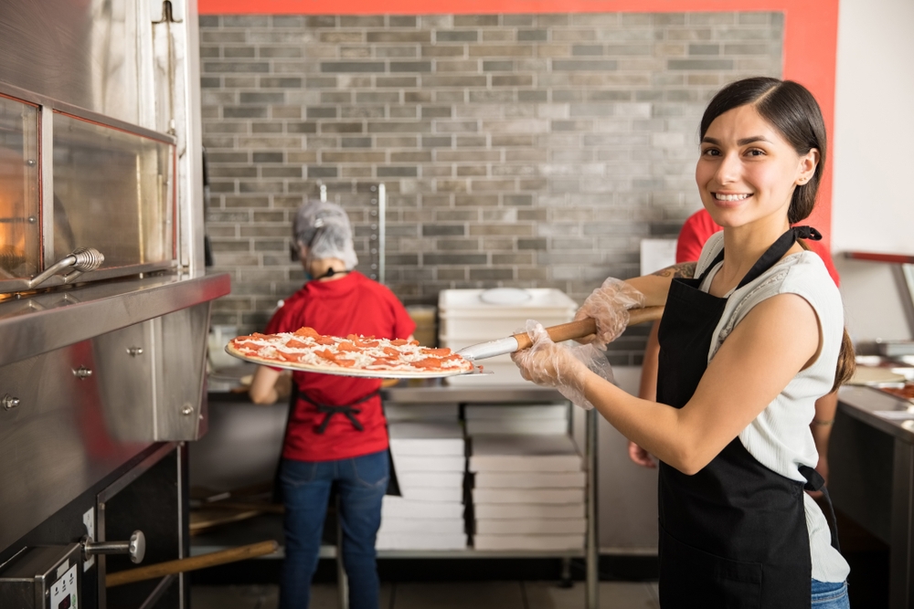 lady holding a pizza pan