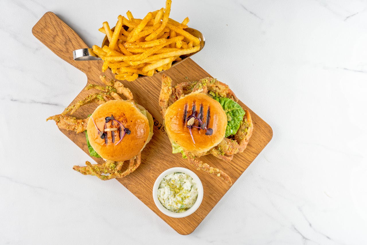 Brown Wooden Chopping Board With Burger Sliced Tomato and Green Vegetable