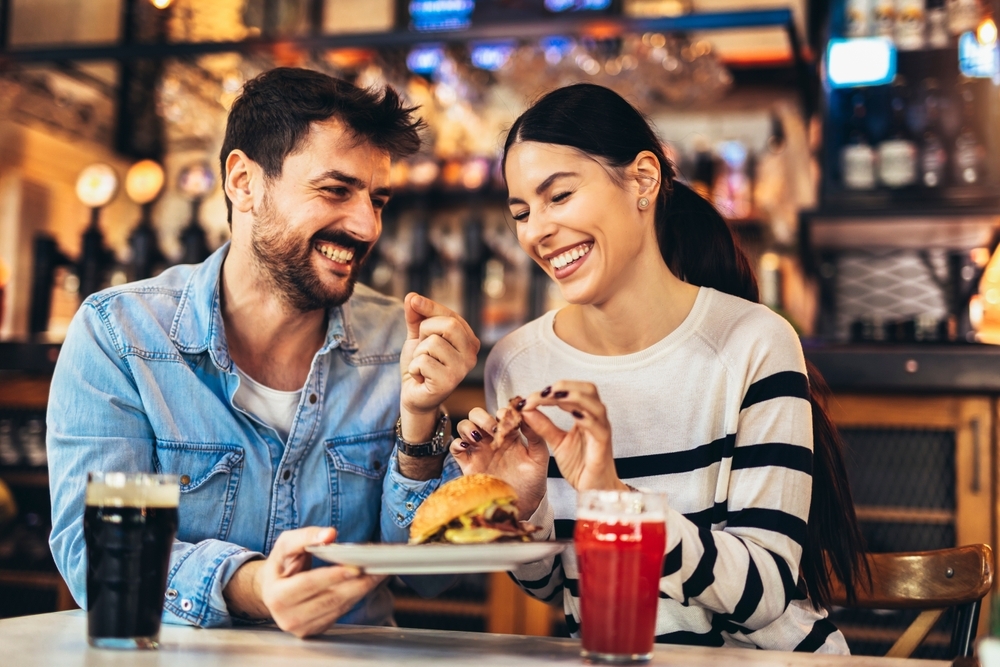 young couple eating burger