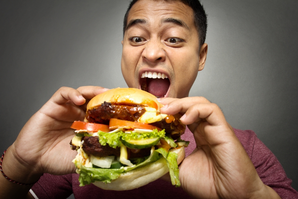 young man eating burger