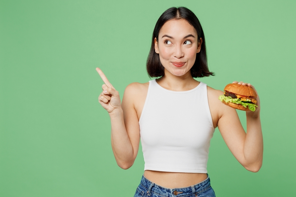 young woman holding a burger