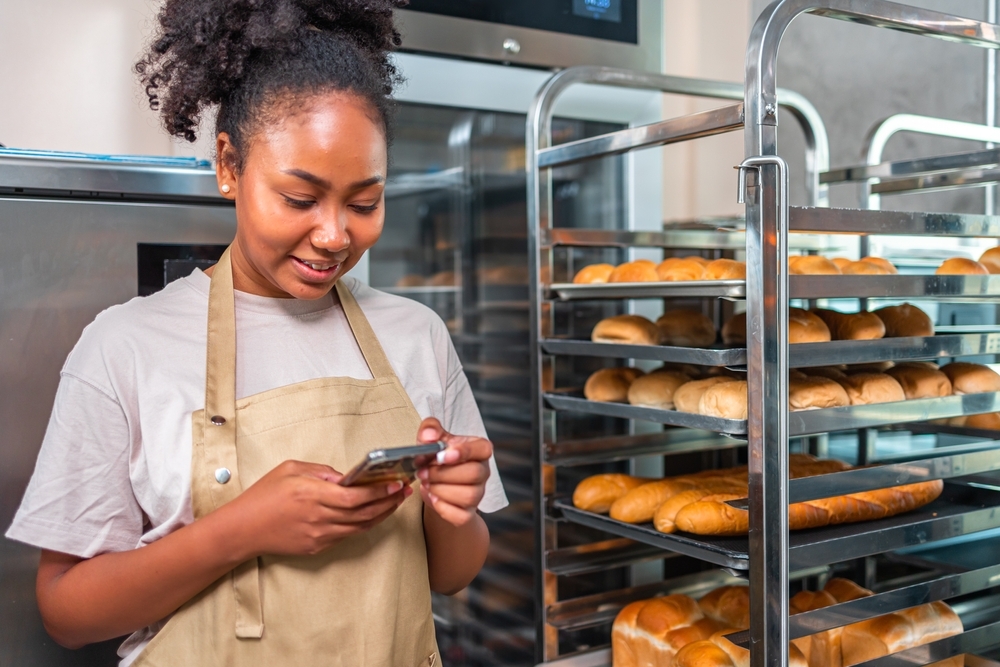 bakery shop owner operating her phone