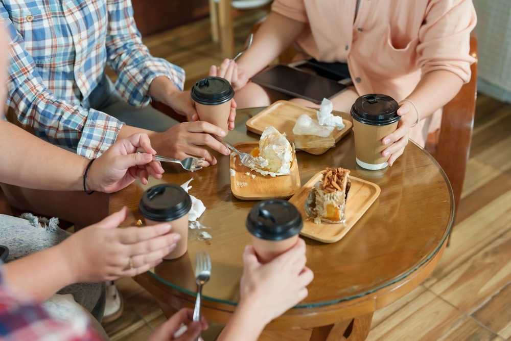 group of friends having lunch and drinking coffee