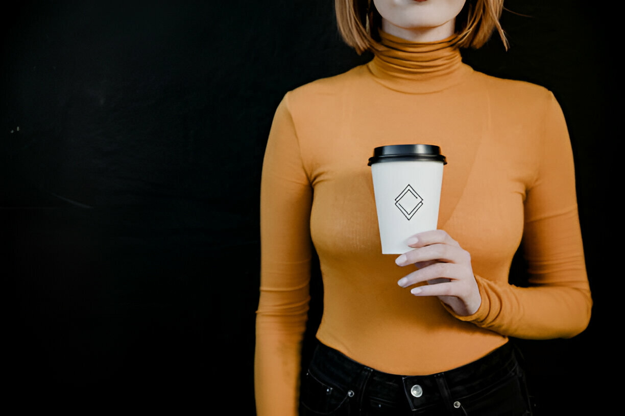 lady holding a branded coffee paper cup