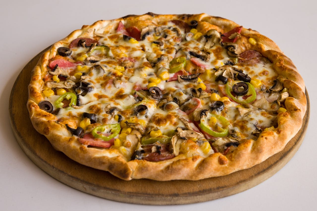 Pizza With Meat and Vegetables Toppings