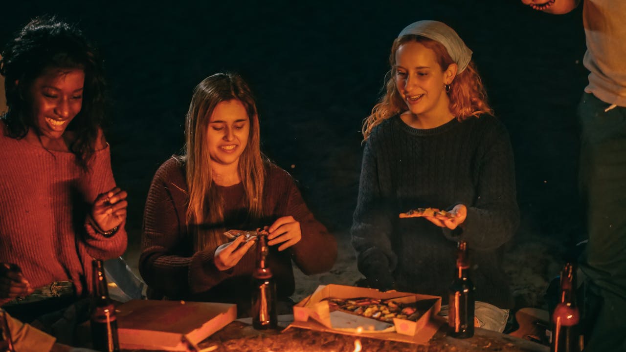 Women Eating Pizza and Drinking Beer