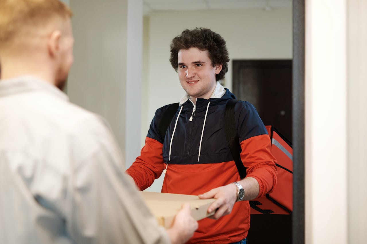 A Delivery Man Carrying a Pizza Box