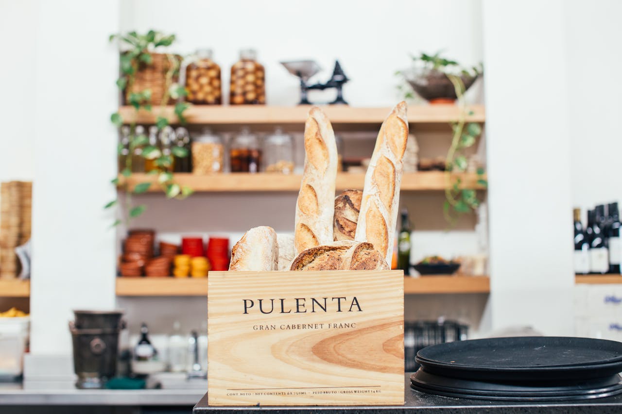 Crispy baguettes in wooden box in counter of Bakery