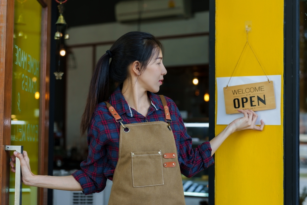 pizza shop worker and open sign