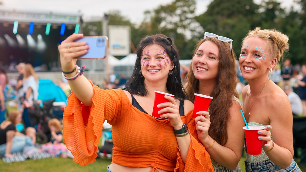 three female friends wearing glitter and posing for pictures