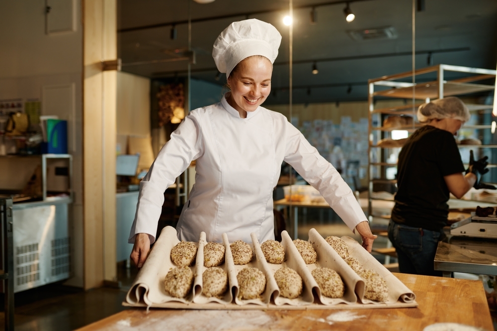 woman baker preparing sweet buns pastries