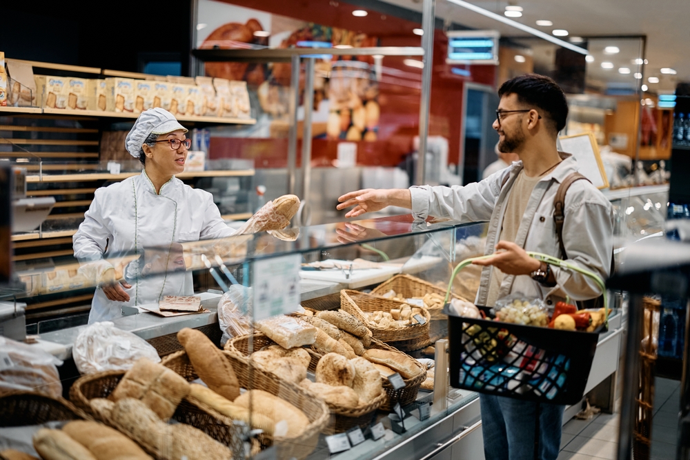 young man buying bread at the bakery