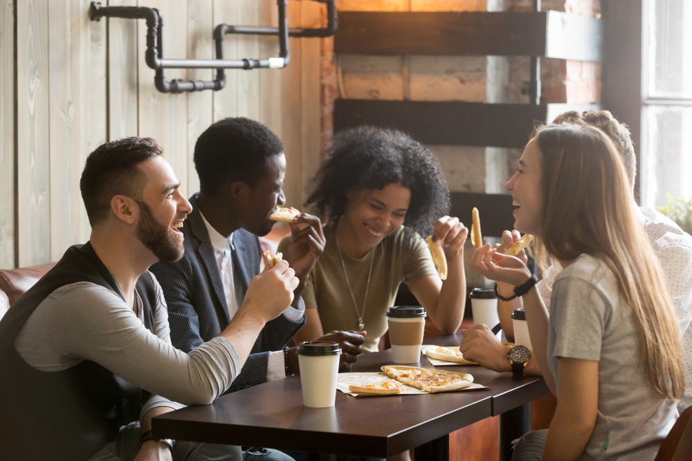 young people eating pizza