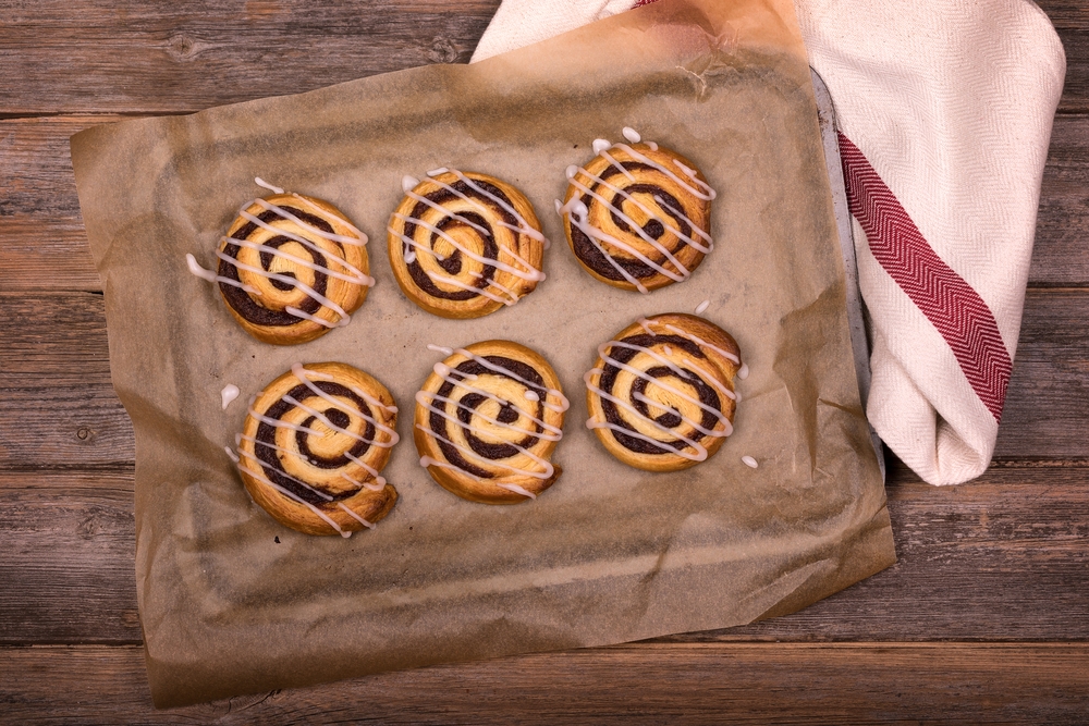 View Of Freshly Baked Cinnamon Buns On Greaseproof Paper