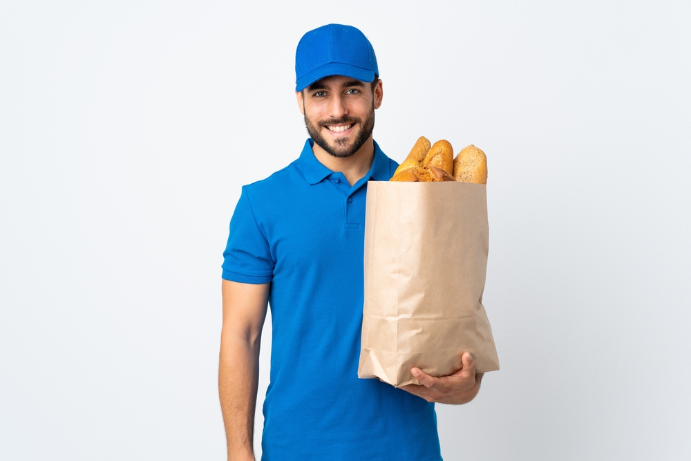 bakery delivery man holding bag full of breads