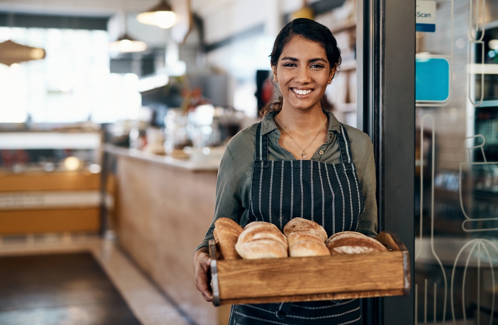 bakery owner carrying freshly baked bread