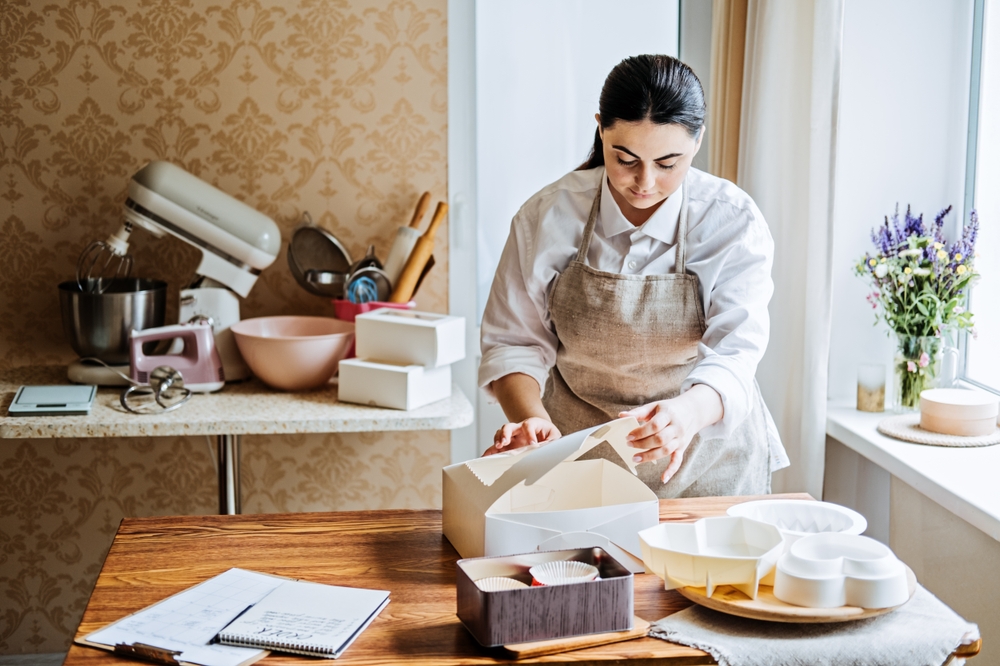 female baker packaging cake