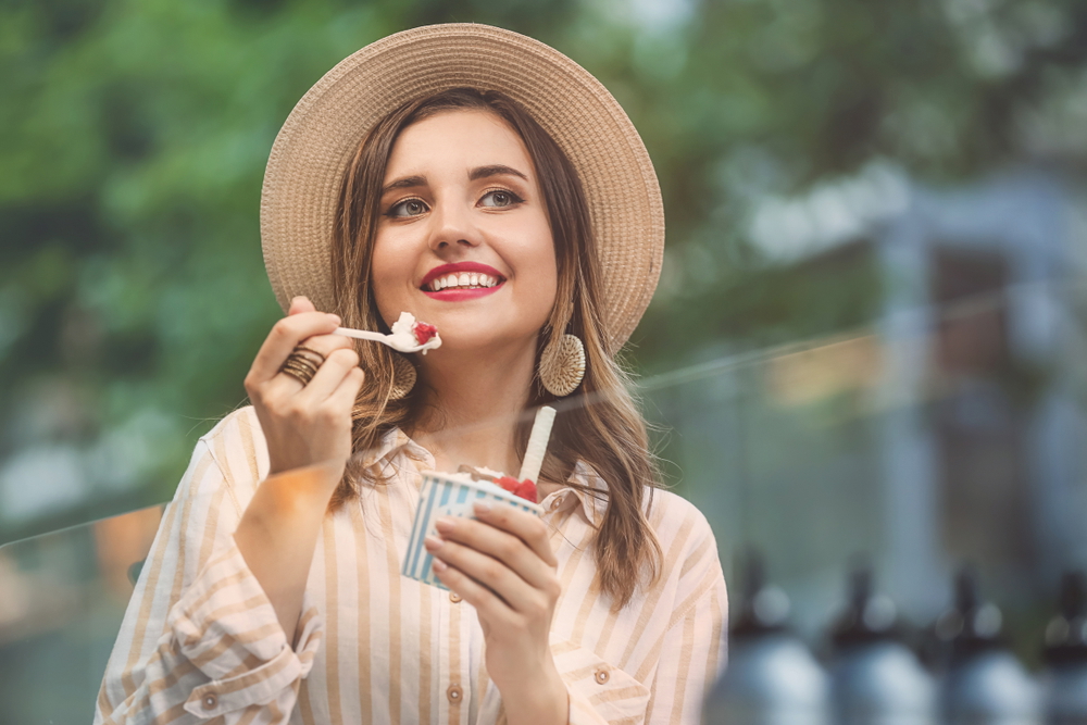 young woman eating tasty ice cream